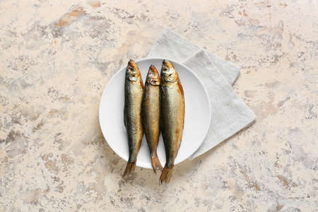 Plate with smoked herring fishes on beige backgroundの写真素材