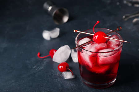 Glass of tasty Manhattan cocktail on black backgroundの写真素材