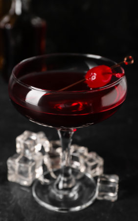 Glass of tasty Manhattan cocktail on black backgroundの写真素材