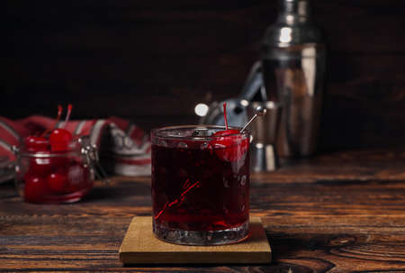 Glass of tasty Manhattan cocktail on tableの写真素材