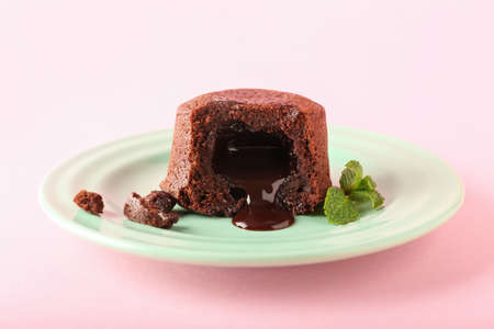 Plate with tasty lava cake fondant and mint on pink background, closeupの写真素材