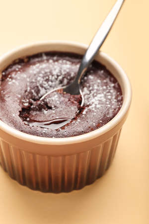 Ramekin with tasty lava cake fondant on beige background, closeupの写真素材