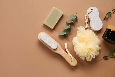 Bath supplies and eucalyptus branches on color background