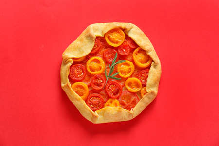 Tasty tomato galette on red backgroundの写真素材