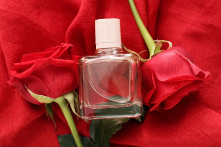 Perfume and roses for Valentine's day on fabric background, closeupの写真素材
