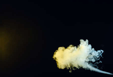 color smoke on black backgroundの写真素材