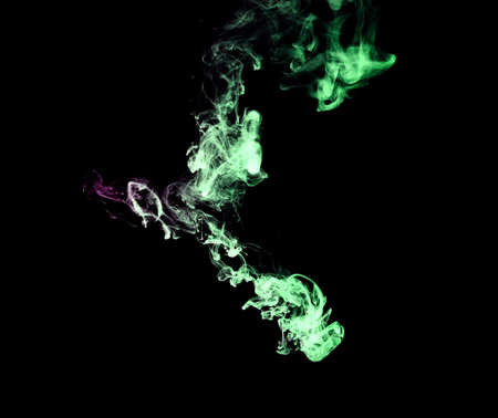 color smoke on black backgroundの写真素材