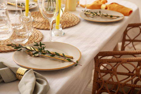 Dining table with beautiful setting and floral decorの写真素材