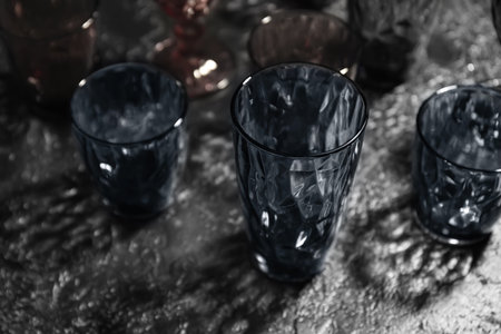 Different empty glasses on dark backgroundの写真素材