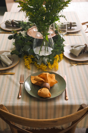 Dining table with beautiful setting and floral decor