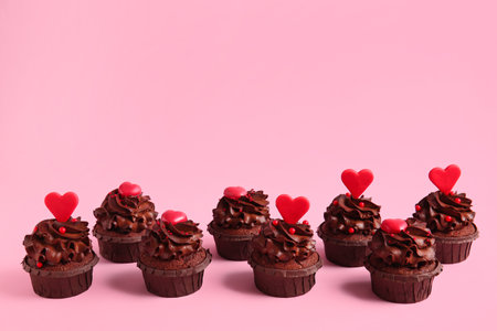 Tasty chocolate cupcakes for Valentine's day on pink backgroundの写真素材