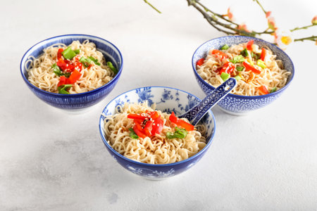 Bowl of tasty noodles on light background