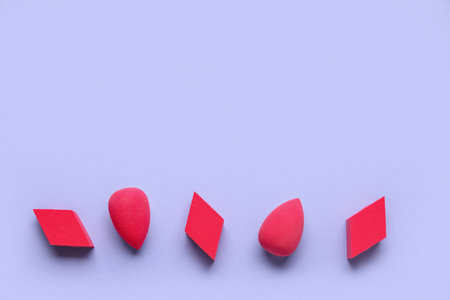 Different makeup sponges on purple backgroundの写真素材