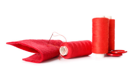 Sewing threads with needles and buttons on white background