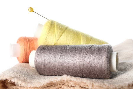 Sewing threads with needle on white background, closeup