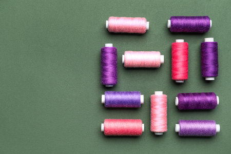 Different sewing threads on green backgroundの写真素材