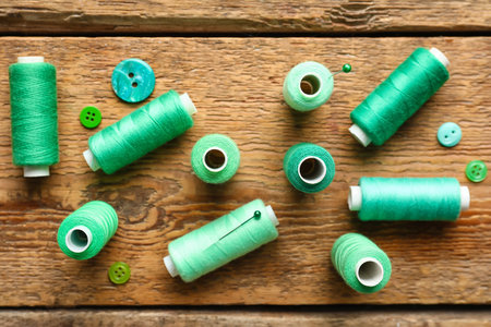 Sewing threads with buttons on wooden backgroundの写真素材
