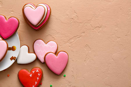 Tasty heart shaped cookies on beige background