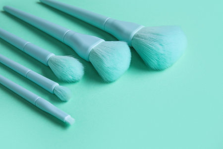 Set of makeup brushes on turquoise background, closeupの写真素材