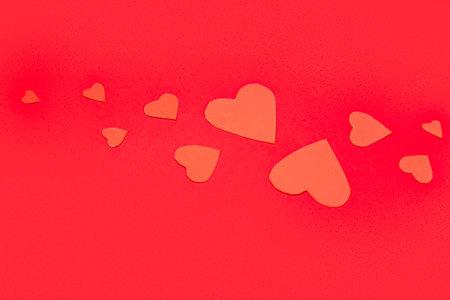 Beautiful paper hearts on red background. St. Valentine's Day
