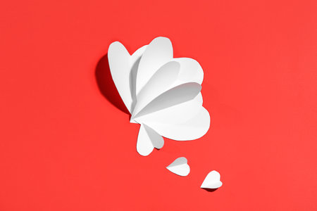Beautiful white paper hearts on red background. St. Valentine's Dayの写真素材