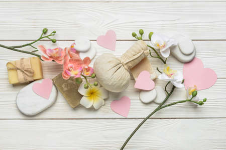 Beautiful spa composition with stones for Valentine's Day celebration on light wooden backgroundの写真素材