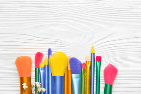 Set of makeup brushes on light wooden backgroundの写真素材