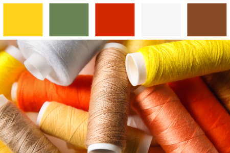 Heap of spools with different sewing threads, closeup. Different color patterns