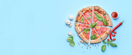 Tasty pepperoni pizza on light blue background with space for textの写真素材