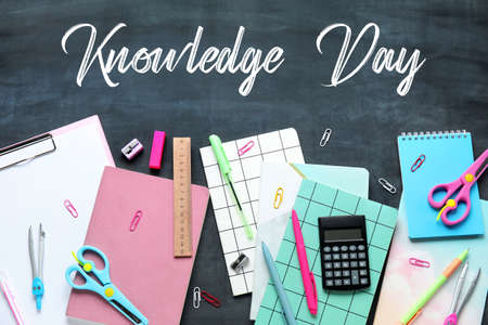 School stationery on blackboard with text KNOWLEDGE DAYの写真素材