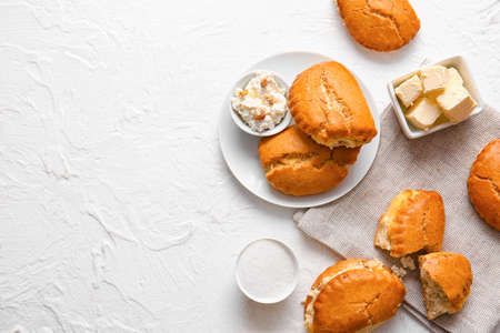 Plate of tasty sochniki with cottage cheese on white background