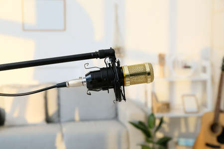 Modern stand with microphone in room, closeup