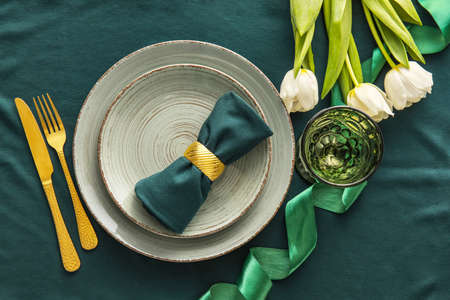 Beautiful table setting with tulips on fabric backgroundの写真素材