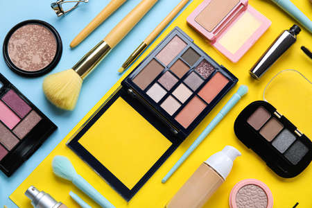 Beautiful makeup brushes with decorative cosmetics on color backgroundの写真素材