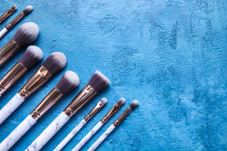 Set of makeup brushes on blue backgroundの写真素材