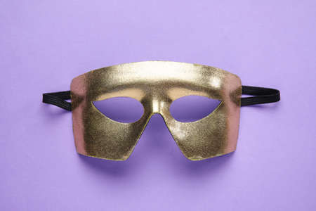 Beautiful mask for Purim holiday on lilac backgroundの写真素材