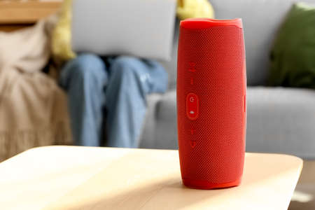 Wireless portable speaker on table in roomの写真素材