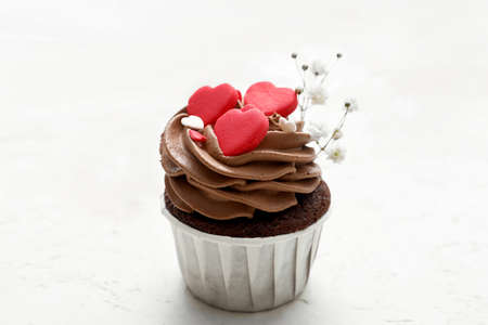 Tasty chocolate cupcake for Valentine's Day on white backgroundの写真素材