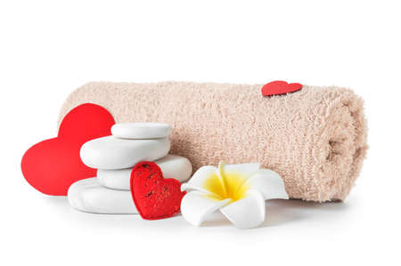 Spa stones, flower and towel isolated on white background. Valentine's Day celebrationの写真素材