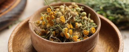Wooden bowl with dried herbs on table, closeupの写真素材