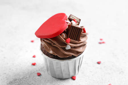 Tasty chocolate cupcake for Valentine's Day on light backgroundの写真素材