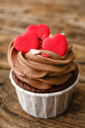 Tasty chocolate cupcake for Valentine's Day on wooden backgroundの写真素材