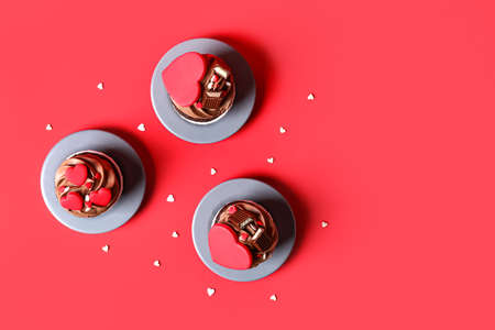 Tasty chocolate cupcakes for Valentine's Day on red backgroundの写真素材