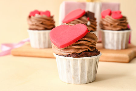 Tasty chocolate cupcakes for Valentine's Day on beige backgroundの写真素材
