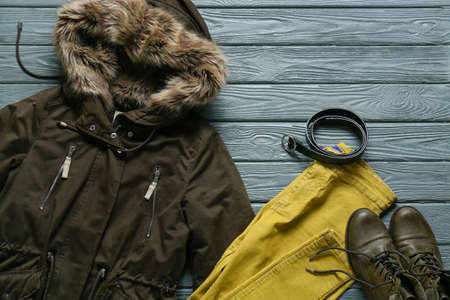Stylish jacket, pants, belt and shoes on gray wooden backgroundの写真素材