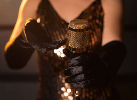 Female singer holding professional microphoneの写真素材