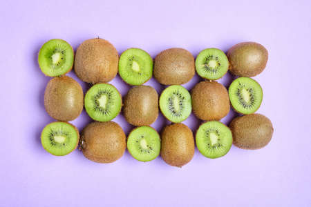 Fresh cut kiwi on purple background