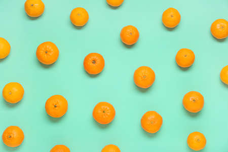 Many ripe tangerines on color backgroundの写真素材