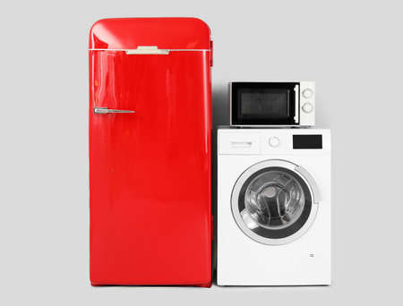 Modern household appliances on light backgroundの写真素材