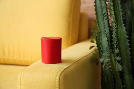Wireless portable speaker on sofa, closeup